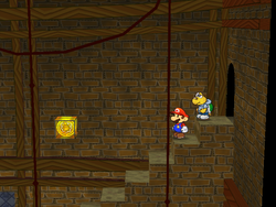 Mario next to the Shine Sprite over the stairs in Riverside Station in Paper Mario: The Thousand-Year Door.