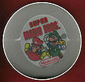 A cereal bowl containing the Super Mario Bros. logo, Mario, and Luigi (a recolored Green Mario), who is holding a Mushroom
