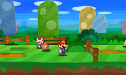 Mario near a bush containing a Heart in Warm Fuzzy Plains of Paper Mario: Sticker Star.