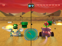 Quicksand Desert arena from Mario Party 5. Boo is driving the vehicle on the right screen.