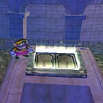 Wario about to enter a steel trapdoor in Wario World
