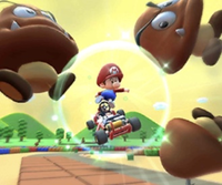 Thumbnail of the Peachette Cup challenge from the Mario Bros. Tour; a Goomba Takedown challenge set on RMX Mario Circuit 1 (reused as the Metal Mario Cup's bonus challenge in the Mario vs. Luigi Tour)