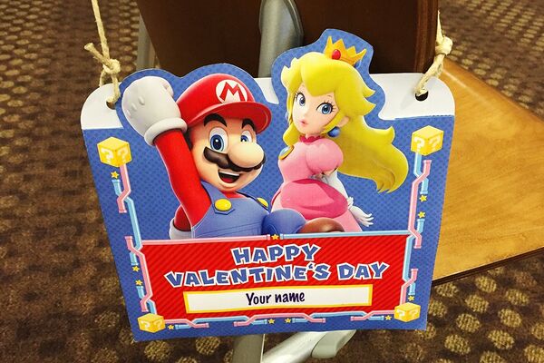 Photograph of a printed Valentine's Day card envelope featuring Mario and Princess Peach