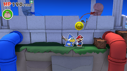 Mario standing near a 100-Coin in Shangri-Spa of The Origami King.