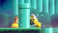 Daisy pushing a pipe towards a Shova in Super Mario Bros. Wonder