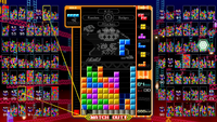 The Donkey Kong theme in Tetris 99, showing 25m on the left and 75m on the right, what appears to be a fire under the stages, and the general gameplay view,.