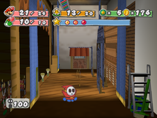 A Shy Guy runs behind the stage