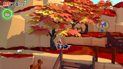 Mario standing near a tree containing a Small Bag of Confetti in Autumn Mountain of The Origami King.