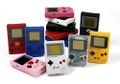 Different types of Game Boys. Notice the red Game Boy with the Manchester United logo at the left.