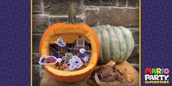 Photograph of a printed Horror Land diorama inside a carved out pumpkin