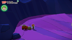 Mario standing near a rock containing a Small Bag of Confetti in Scorching Sandpaper East of The Origami King.