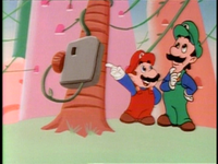 Mario shows off his new pay phone to Luigi.
