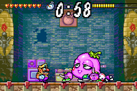 Screenshot of Wario battling Spoiled Rotten, who is accompanied by two Petit-size no Pinkīs