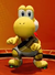 Image of Yoshi in a yellow uniform, from Mario Strikers: Battle League