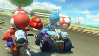 Red and Light-blue Yoshis, racing at GCN Yoshi Circuit.