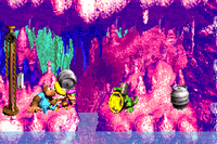Dixie Kong holding a Steel Barrel at the Koin at the end of Bazza's Blockade in the Game Boy Advance remake of Donkey Kong Country 3