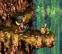 Dixie Kong holding a Steel Barrel to the Koin of Tracker Barrel Trek in Donkey Kong Country 3: Dixie Kong's Double Trouble!