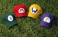 Baseball caps based on (from left to right) Luigi's, Mario's, Wario's, and Waluigi's hats
