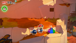 Mario standing near a Big Bag of Confetti in Chestnut Valley of The Origami King.