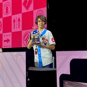 Photograph of Kevo, winner of the Mario Kart 8 Deluxe Championship 2023 tournament. The image was originally posted on the social networking website X by the NintendoVS account along with the following text:🏁 Kevo dominated the track in style. 🏁 Congrats to Kevo, winner of the #NintendoLive #MarioKart 8 Deluxe Championship 2023! And thanks to everyone who qualified through the Mario Kart 8 Deluxe Championship 2023 Qualifier online and at Nintendo Live!