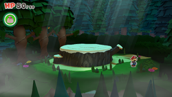 Mario standing near a bush containing a Small Bag of Confetti in Whispering Woods of The Origami King.