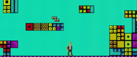 A scene from the film Tetris, showing a pixelated Henk Rogers in a place made of tetrominoes resembling a Super Mario Bros. level. The tetromino acts as a Super Mushroom.