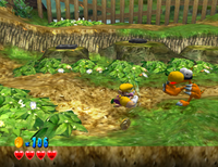 Wario using the Dash Attack toward a large Magon in Wario World