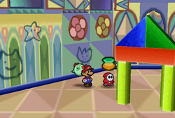 Mario finding Maple Syrup held by a red Shy Guy in Shy Guy's Toy Box of Paper Mario.