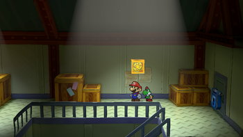 Mario next to the Shine Sprite on the second floor of Glitz Pit's storeroom in the remake of the Paper Mario: The Thousand-Year Door for the Nintendo Switch.