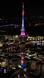 An advertisement for The Super Mario Galaxy Movie being projected on the Sky Tower in Auckland, New Zealand