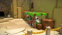 The fifty-sixth hidden Toad in Picnic Road, disguised as a red origami Mushroom in a shop. Mario can only rescue this Toad after first rescuing all hidden Toads in the Earth Vellumental Temple.