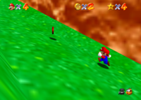 Mario approaching a Red Coin in Bob-omb Battlefield