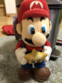 Larger plushie of Mario holding a Power Star