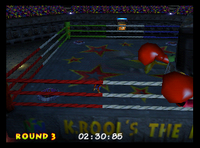 Lanky Kong walking onto a Music Pad in a corner of the ring during the final battle at the boxing arena in Donkey Kong 64