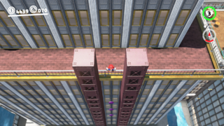 Between some iron girders on the back side of the New Donk City Hall.