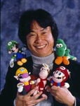 A photo of Shigeru Miyamoto along with his toy characters