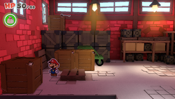 Mario standing near a crate containing a 10-Coin in Toad Town of The Origami King.