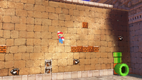 E3 2017 screenshot of 8-bit Mario in the Tostarena Ruins of the Sand Kingdom in Super Mario Odyssey.