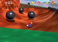 Early screenshot of Mario taking a path with three iron balls