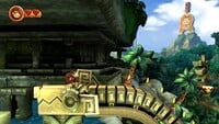 Wonky Waterway in Donkey Kong Country Returns HD, with the statue of Donkey Kong holding a Joy-Con in the background