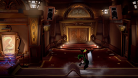 The theater entrance with the Poltergust G-00 lifting Luigi, hence burst