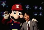 Shigeru Miyamoto and a Mario mascot, standing in front of a MIRT display