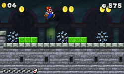 Raccoon Mario, flying over some spiked balls in World 4-Castle.