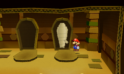 Mario near an opened coffin containing a POW Block Sticker in Sandshifter Ruins of Paper Mario: Sticker Star.