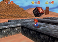 An early image of Mario in Shifting Sand Land, on a path over the quicksand. He has five stars, which is below the minimum star requirement to access Mushroom Castle's basement (where the world's painting is located) in the final version. The Tox Box is also placed oddly.