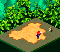 Screenshot of Mario punching a Goomba in Super Mario RPG: Legend of the Seven Stars