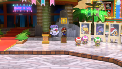 Mario next to the Shine Sprite in the arena of Glitzville in the remake of the Paper Mario: The Thousand-Year Door for the Nintendo Switch.