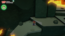 Mario standing near a rock containing a Small Bag of Confetti in Earth Vellumental Temple of The Origami King.
