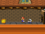 Mario next to the Shine Sprite after the wall to the left of the store in west Rogueport