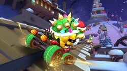 Bowser (Santa) and Yoshi (Reindeer) on the train tracks of Merry Mountain in Mario Kart Tour